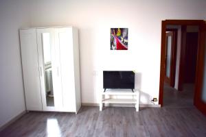 a living room with a tv and a door at Panoramical appartment Lecco in Lecco