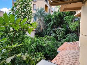 a garden with trees and plants on a building at Pharana Residence in Alexandria