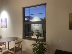 a window in a room with a table and a plant at Twins Guest House in Telavi