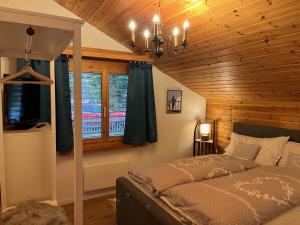 a bedroom with a bed and a window at Casa Tresch Sedrun Tujetsch bis 5 Pers in Sedrun +26 photos