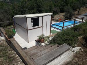 a small house with a pool in the background at Casa vacanze Il cancello rosso in Montefranco