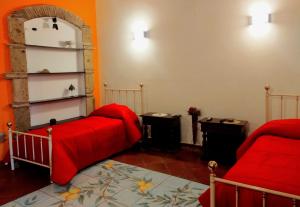 a room with two beds and a red blanket at Black Stone in Pompei
