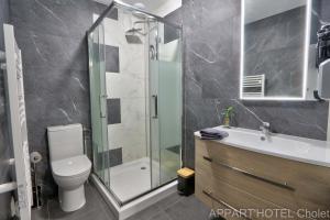 a bathroom with a shower and a toilet and a sink at Appart' hôtel Cholet in Cholet