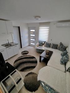 a living room with a couch and a table at Apartmani Strahinic in Leskovac