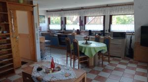 a kitchen with a table and chairs and a table and a kitchen at Ferienwohnung Papsdorf in Bad Münder am Deister +7 photos