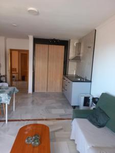 a living room with a couch and a kitchen at Place-To-Relax in San Luis de Sabinillas