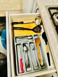 a drawer filled with utensils in a refrigerator at микрорайон 9 in Almaty