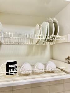 a shelf with plates and dishes on it in a kitchen at микрорайон 9 in Almaty