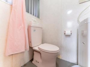 a bathroom with a toilet and a pink towel at Shinjuku, 3min walk from Nishi-Shinjuku 5-chome Sta, 3min Shinjuku Sta Switch, Wi-Fi ,Pocketwi-Fi in Tokyo