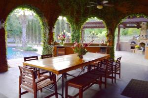 a dining room with a wooden table and chairs at Villa at Cibolo Chase, a private resort with pool in Bulverde