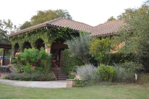 a house with a gazebo with ivy on it at Villa at Cibolo Chase, a private resort with pool in Bulverde