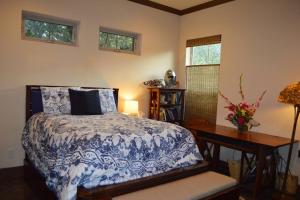 a bedroom with a blue and white bed and a desk at Villa at Cibolo Chase, a private resort with pool in Bulverde +42 photos