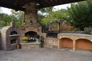 an outdoor pizza oven with a stone wall at Villa at Cibolo Chase, a private resort with pool in Bulverde