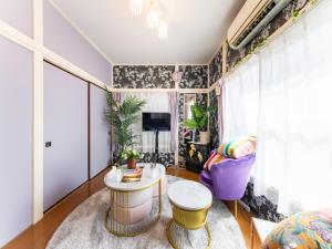 a living room with a table and a tv at Shinjuku, 3min walk from Nishi-Shinjuku 5-chome Sta, 3min Shinjuku Sta Switch, Wi-Fi ,Pocketwi-Fi in Tokyo