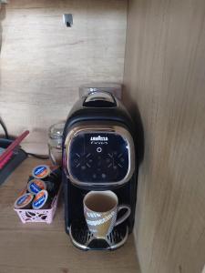 a black coffee maker with a cup of coffee at Mobile Home L&L in Drage