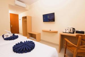 Ένα ή περισσότερα κρεβάτια σε δωμάτιο στο Hotel Dafam Rio