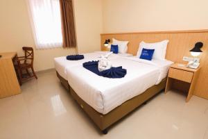 Ένα ή περισσότερα κρεβάτια σε δωμάτιο στο Hotel Dafam Rio