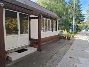 a building with white doors and windows on a street at Apartman Mole in Livno