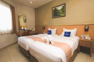 Ένα ή περισσότερα κρεβάτια σε δωμάτιο στο Hotel Dafam Rio