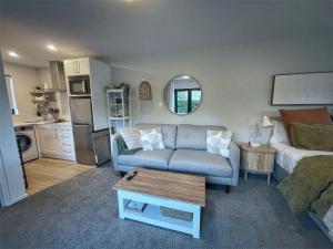 a living room with a couch and a table at #1 Glenorchy Alpine DELUXE Suite in Glenorchy