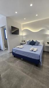 a bedroom with a large blue bed in a room at Panhouse Rooms & Suite in Palermo