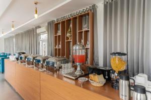 a long counter with food and drinks on it at BA-NA Hills Resort in Salara