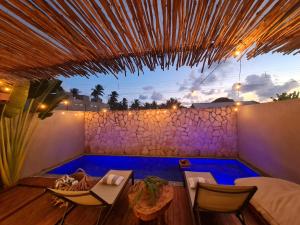 a backyard with a swimming pool and a table and chairs at CASA SALGA - MILAGRES - 3 mins a pé da praia da Capela in São Miguel dos Milagres