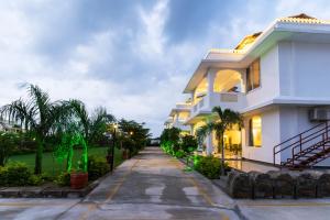 a white house with a driveway at BA-NA Hills Resort in Salara