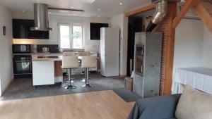 a kitchen with a refrigerator and a table and chairs at Hansi - Adults Only in Lautenbachzell