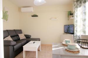 a living room with a couch and a table at Apartamento LUNADA I in Candeleda