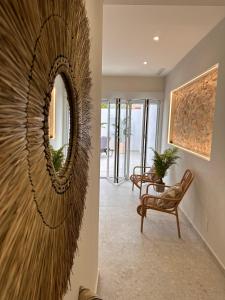 a living room with a mirror and a chair at Casa Pepita - Mediterránea in Benijófar