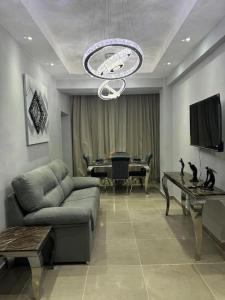 a living room with a couch and a table at Apartamento santo domingo este in Juan López +48 photos