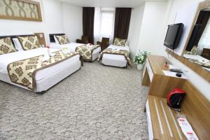 Postel nebo postele na pokoji v ubytování Afyon Grand Arı Hotel