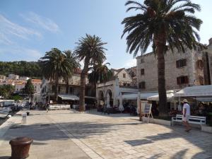 a town square with palm trees and a building at Inn Town Center in Hvar