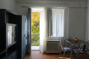 a dining room with a table and a window at Prestige apartman in Miskolc