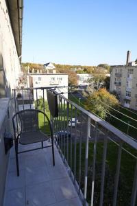 a balcony with a chair and a view of a street at Prestige apartman in Miskolc