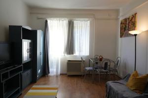a living room with a couch and a table and a window at Prestige apartman in Miskolc