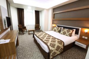 Postel nebo postele na pokoji v ubytování Afyon Grand Arı Hotel