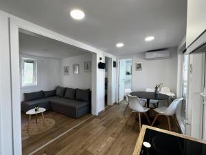 a living room with a couch and a table at Mobile Home Luxor in Grebaštica +49 photos
