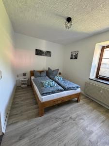 a bedroom with a large bed in a room at Erzgebirgsglück Jöhstadt EG in Jöhstadt