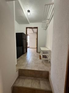 a hallway with a staircase leading to a room at Erzgebirgsglück Jöhstadt EG in Jöhstadt +14 photos