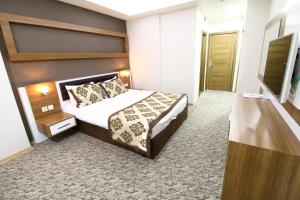 Postel nebo postele na pokoji v ubytování Afyon Grand Arı Hotel
