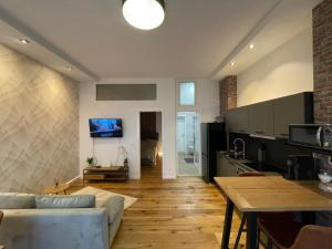 a kitchen and living room with a couch and a table at Ferienwohnung Schulerhaus in Stetten am Kalten Markt