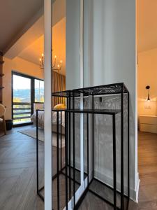 a living room with a glass table in a room at Greg Rooms in Sinaia +40 photos