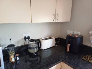 a kitchen counter top with a toaster and a toaster at The Loft in Mtunzini