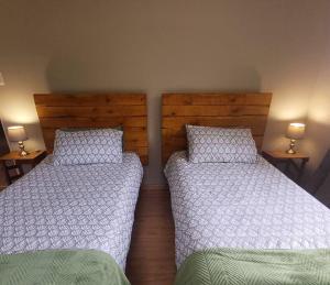 two beds sitting next to each other in a bedroom at The Loft in Mtunzini