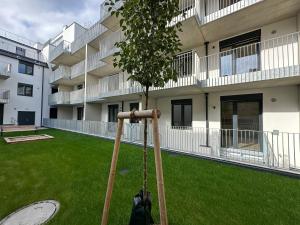a garden with two baseball bats and a building at Schönbrunn Garden Apartments in Vienna