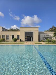 a large swimming pool in front of a house at The Vipingo Retreat in Vipingo