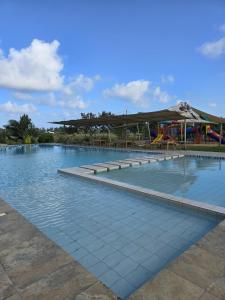 a large swimming pool with a playground in the background at The Vipingo Retreat in Vipingo