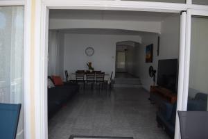 a living room with a couch and a table at Le Rocher Sea Front Villa in Flic-en-Flac